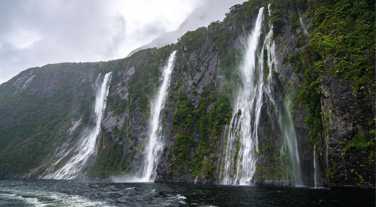 Dozens of temporary waterfalls streaming down Milford Sound's cliff faces after rain