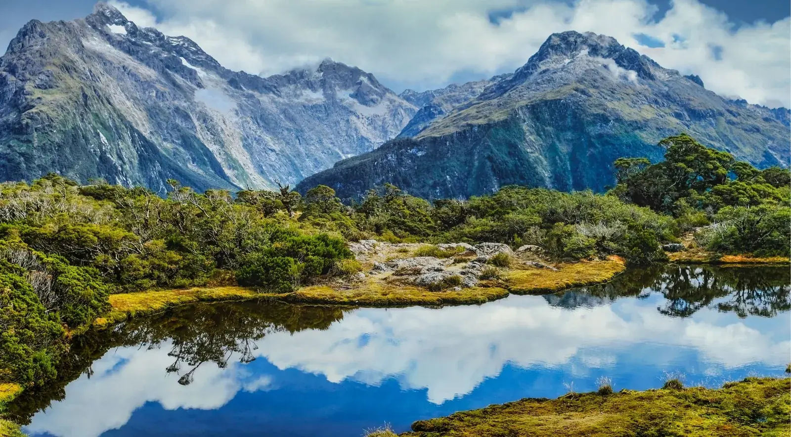 Snow-capped alpine peaks reflected in tarns near Key Summit, Fiordland National Park