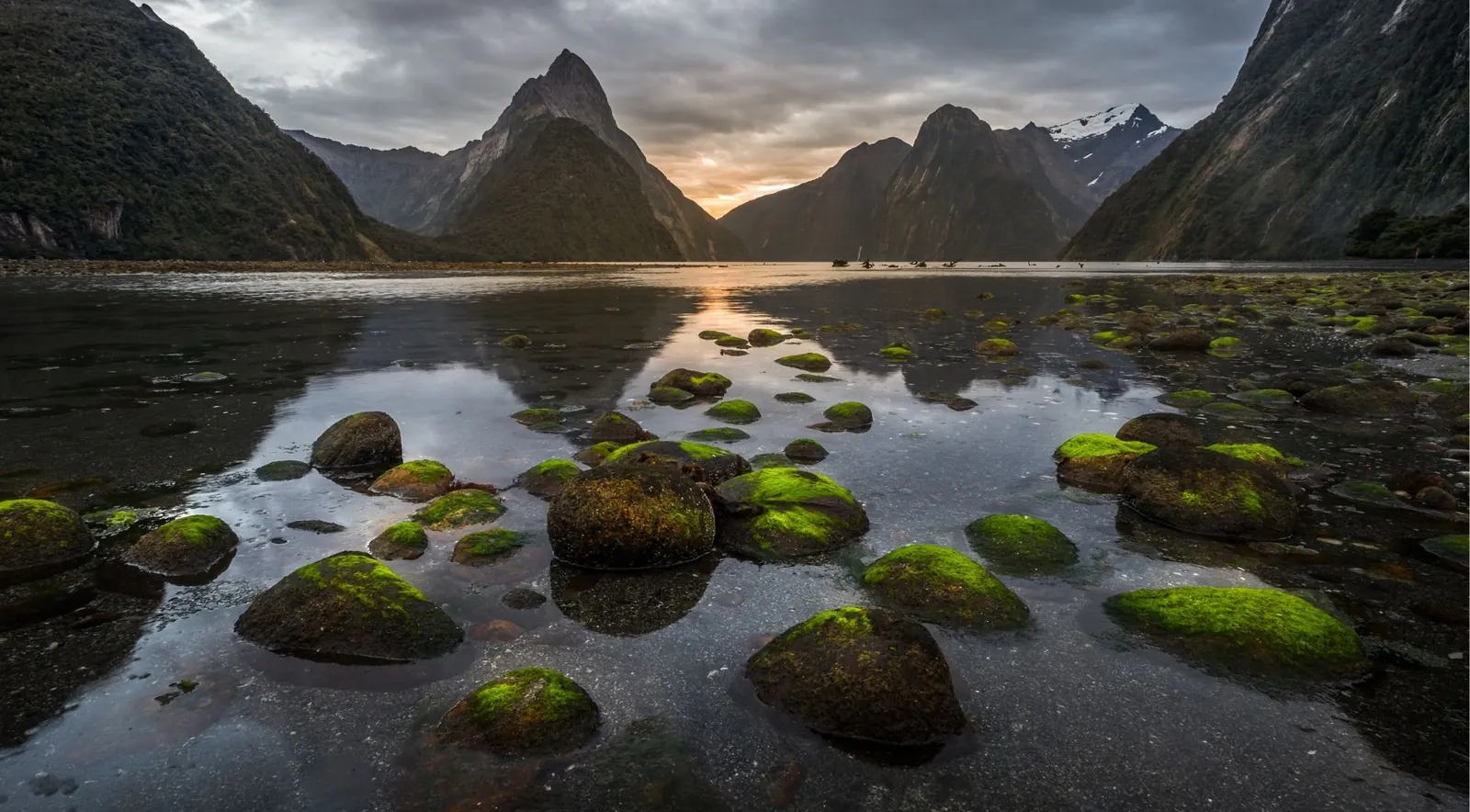 Mitre Peak silhouetted at sunset over Milford Sound